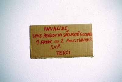 carton, papier, écritures dessus mis a même le mur
